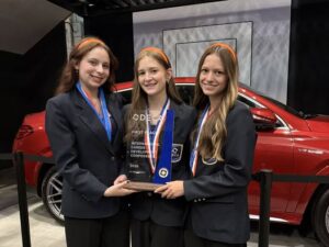 DECA students holding an award