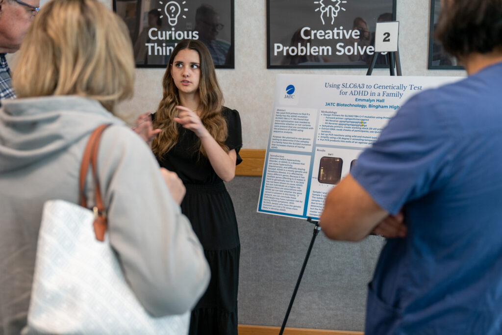 Student presenting their biotech poster